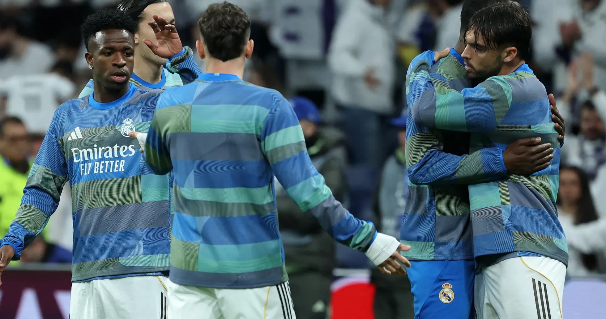 Real Madrid players embracing during warm-up session