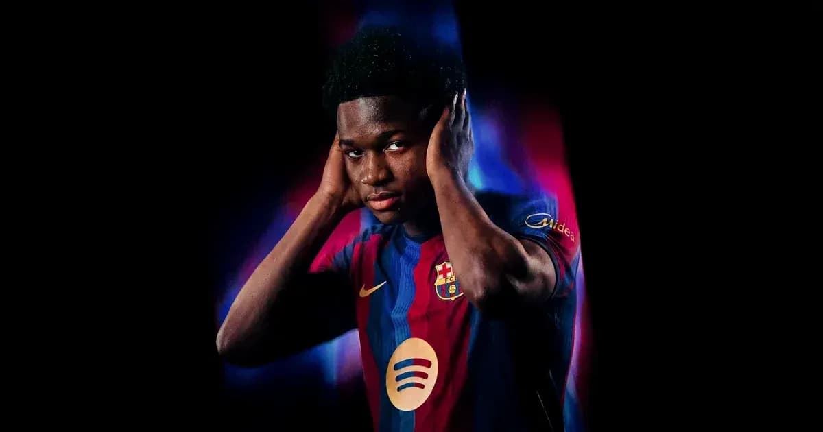 Player in Barcelona jersey posing with hands on ears