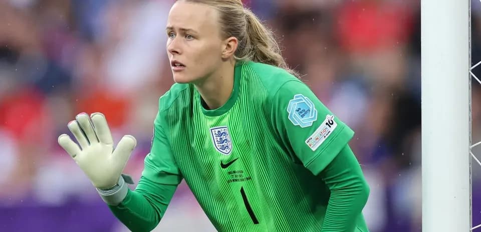 Goalkeeper in green jersey preparing to defend