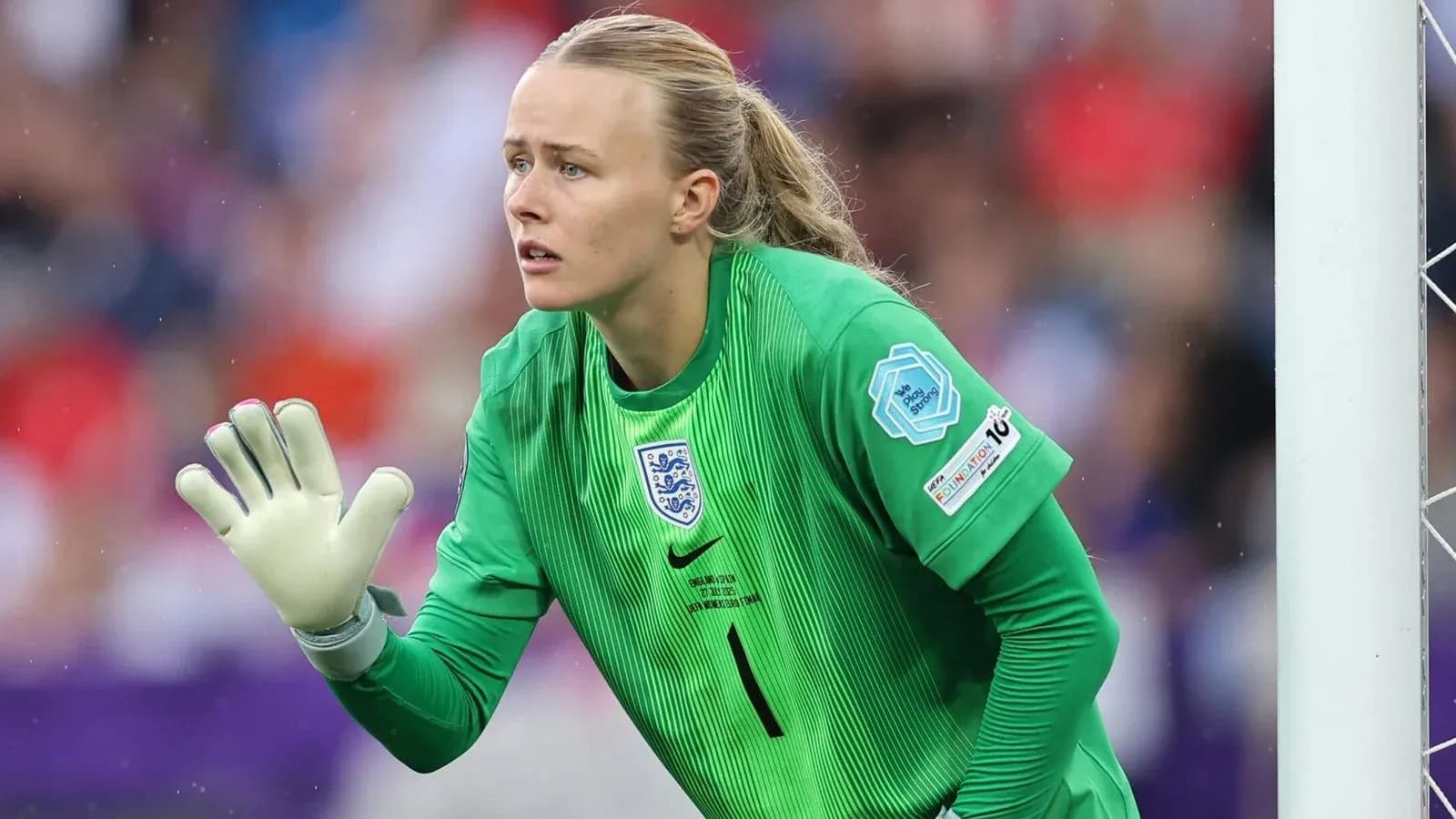 Goalkeeper in green jersey preparing to defend