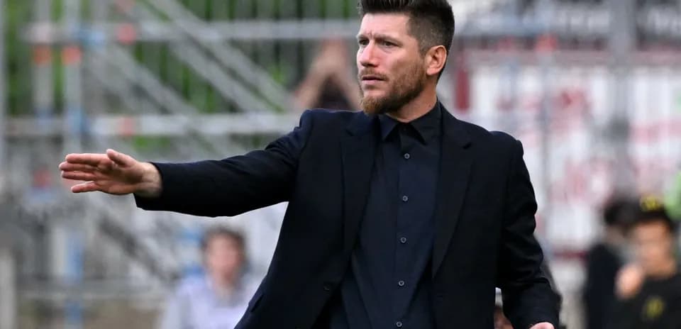 Coach gesturing during a football match