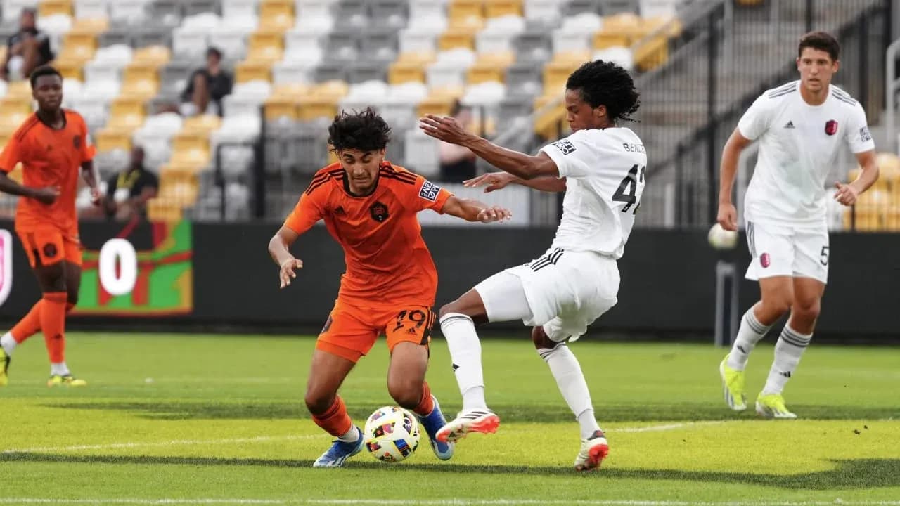 Players competing for the ball in football match