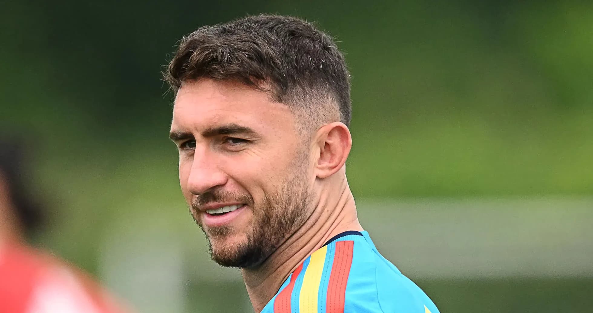 Player in training jersey smiling outdoors