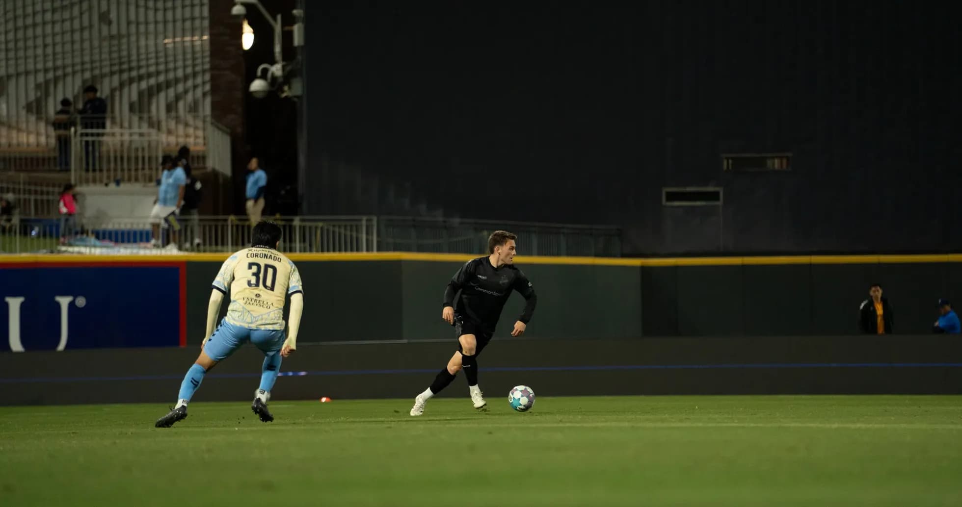 Player dribbling ball during Colorado Springs match