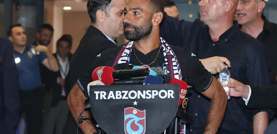 Player at Trabzonspor press conference with microphones