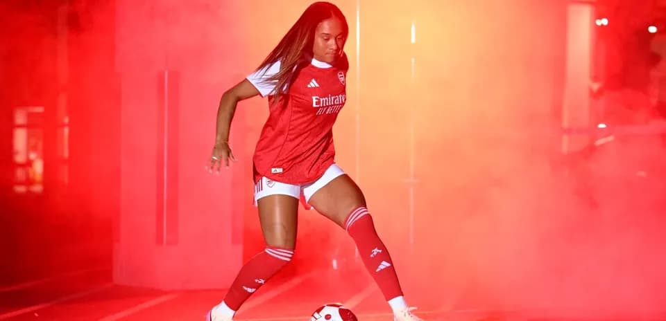 Player in red kit preparing to kick soccer ball