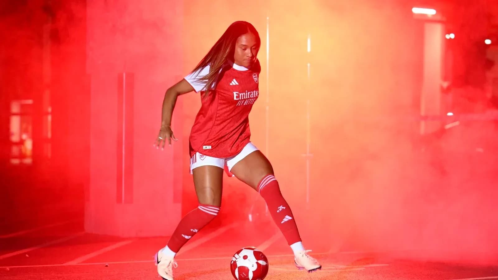 Player in red kit preparing to kick soccer ball