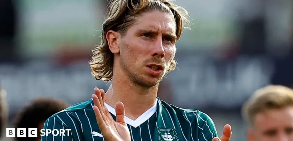 Player applauding fans in green team jersey