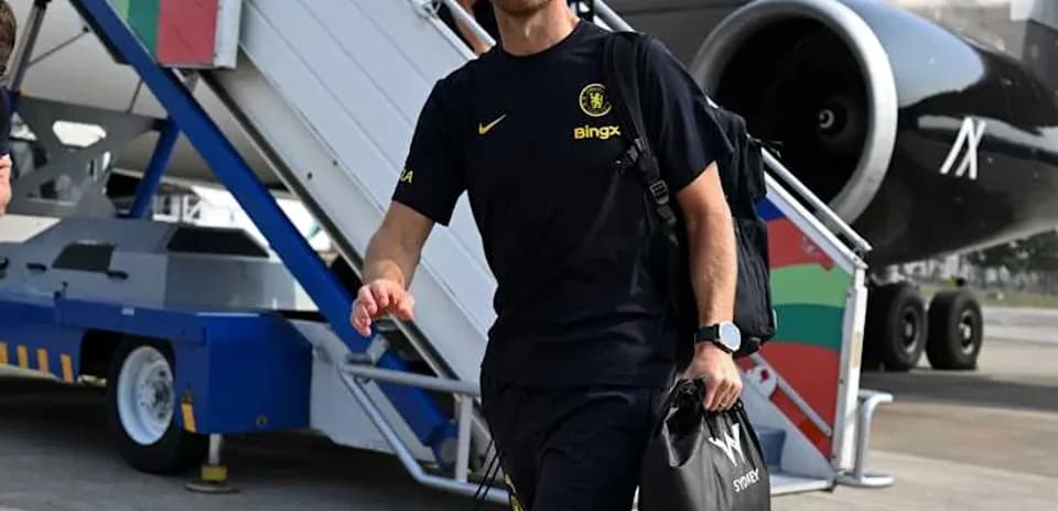 Coach walking down airplane stairs at airport