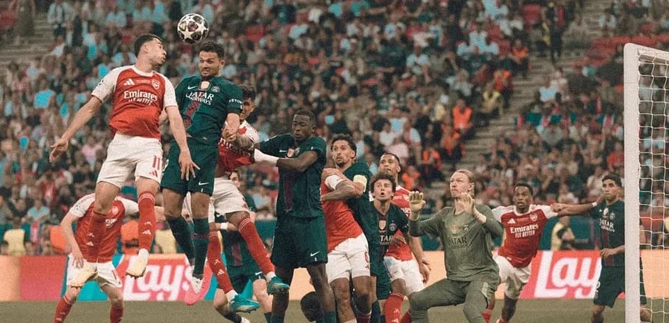 Players contesting for a header in crowded penalty area