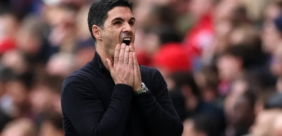 Manager gesturing during a match on the sidelines