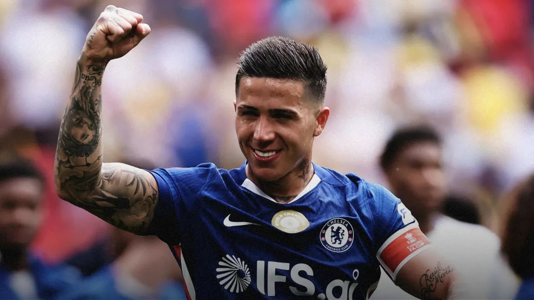 Player celebrating victory with raised fist in jersey