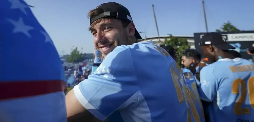 Player smiling during celebration with teammates