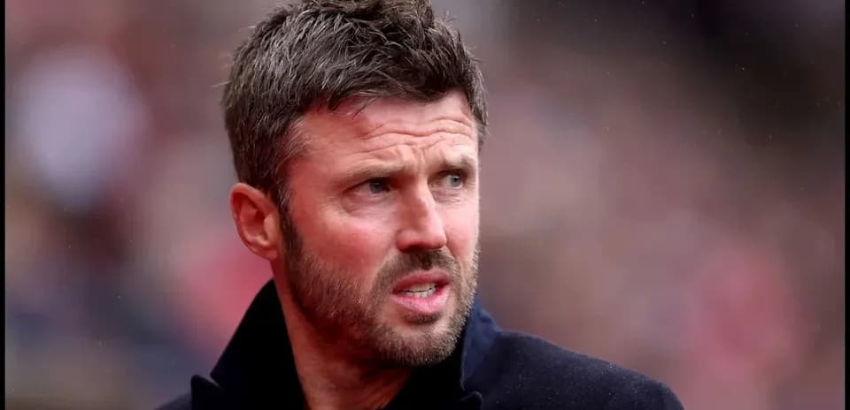 Man in black coat during football match