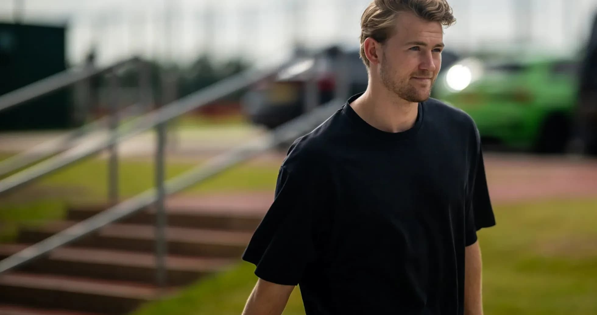 Man walking towards training facility in casual attire