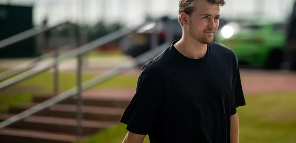 Man walking towards training facility in casual attire