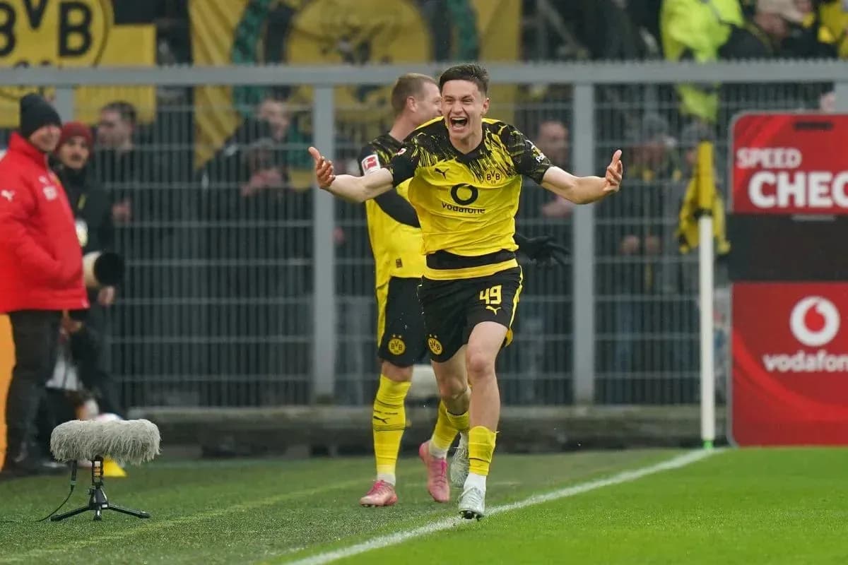 Player celebrating a goal with teammates on field