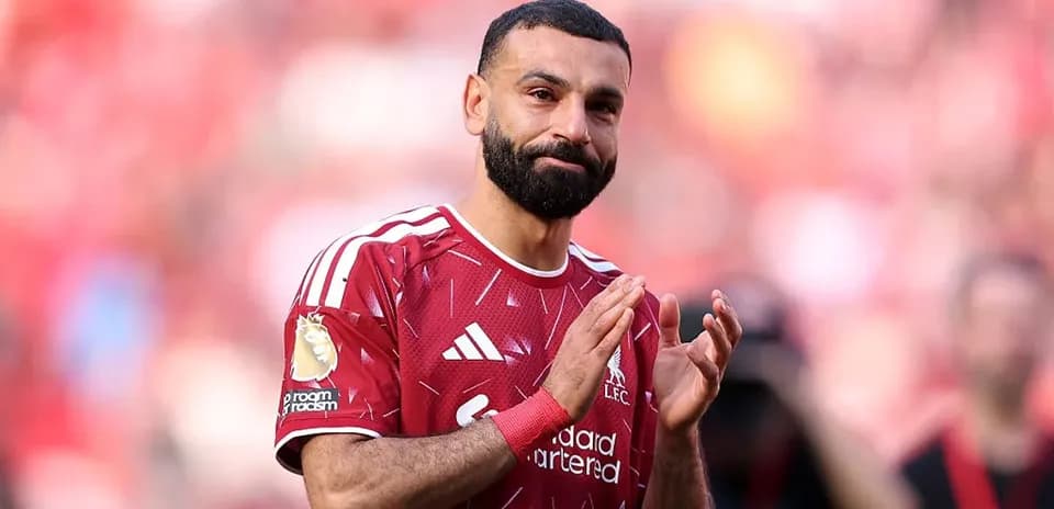 Player applauding fans in Liverpool kit