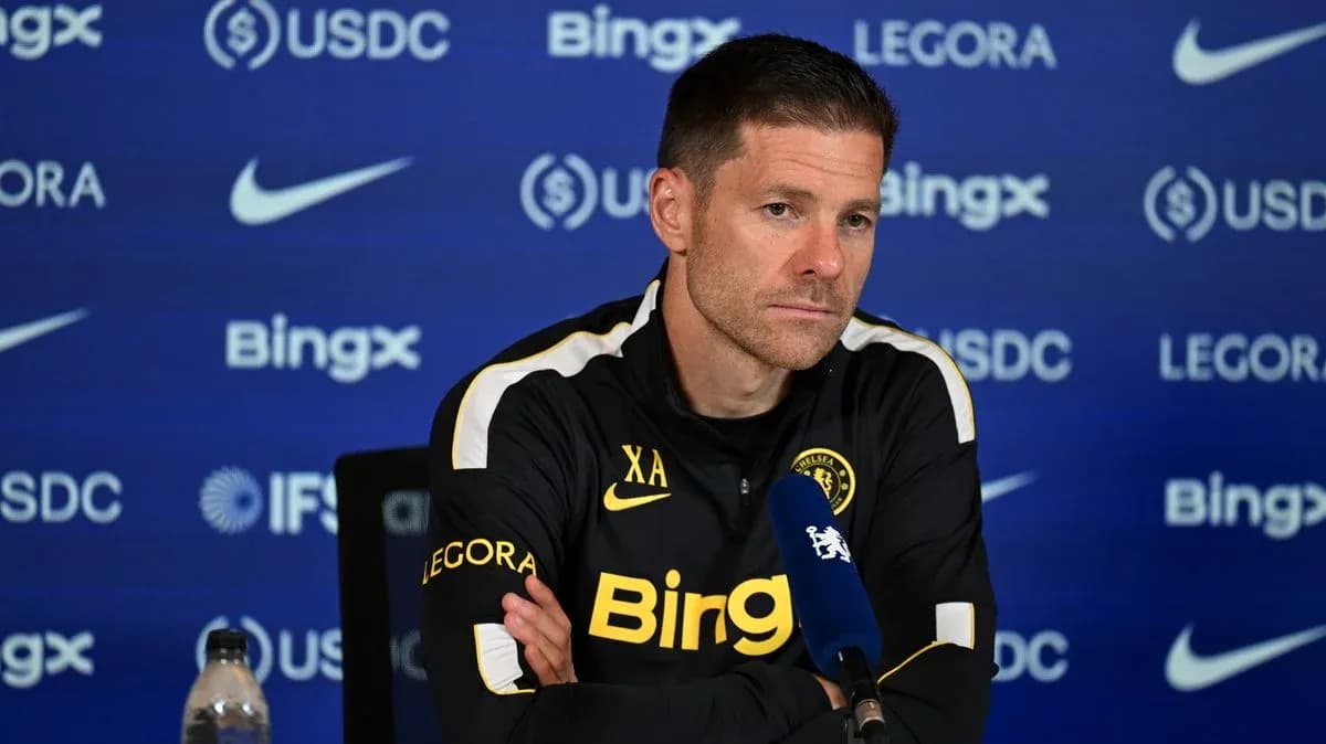 Manager speaking at press conference with sponsor backdrop