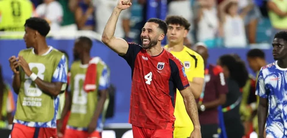 Player celebrating victory with raised fist on field