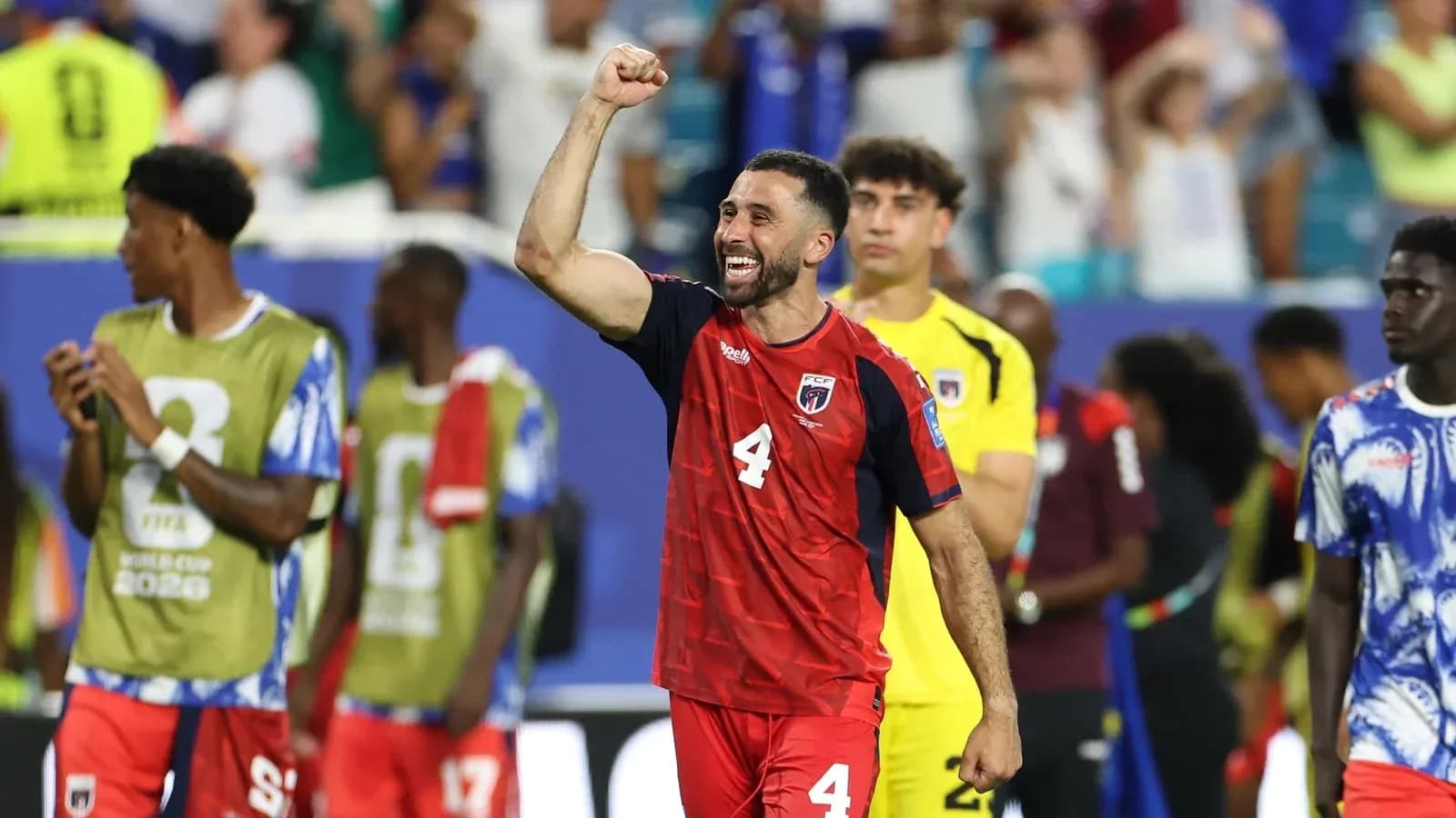 Player celebrating victory with raised fist on field