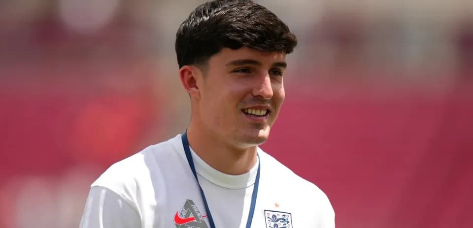 Player in England jersey smiling during warm-up