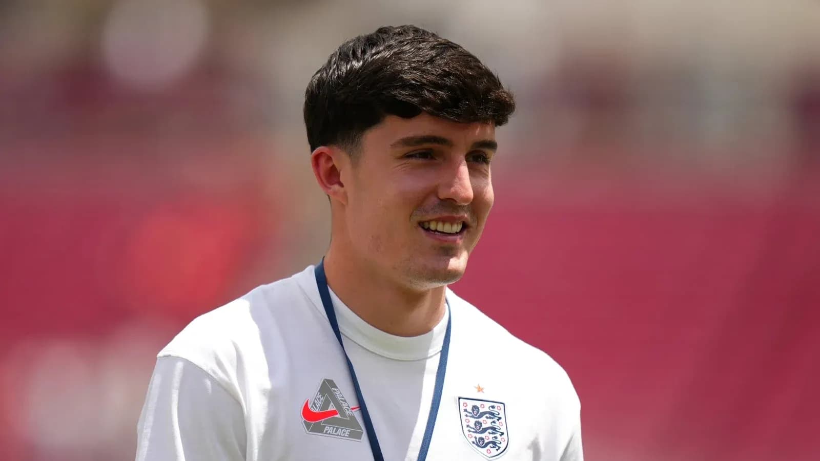 Player in England jersey smiling during warm-up