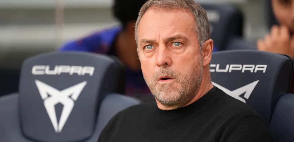 Coach seated on bench during match