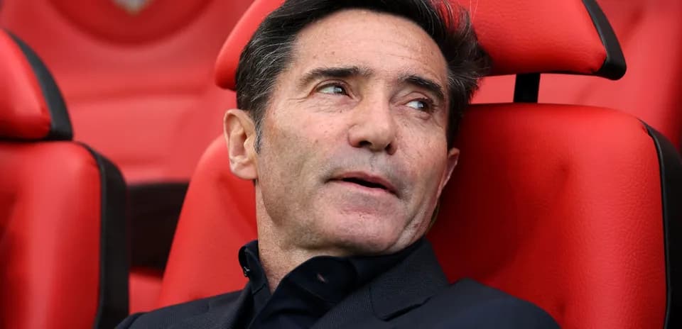 Coach seated on the bench during a match