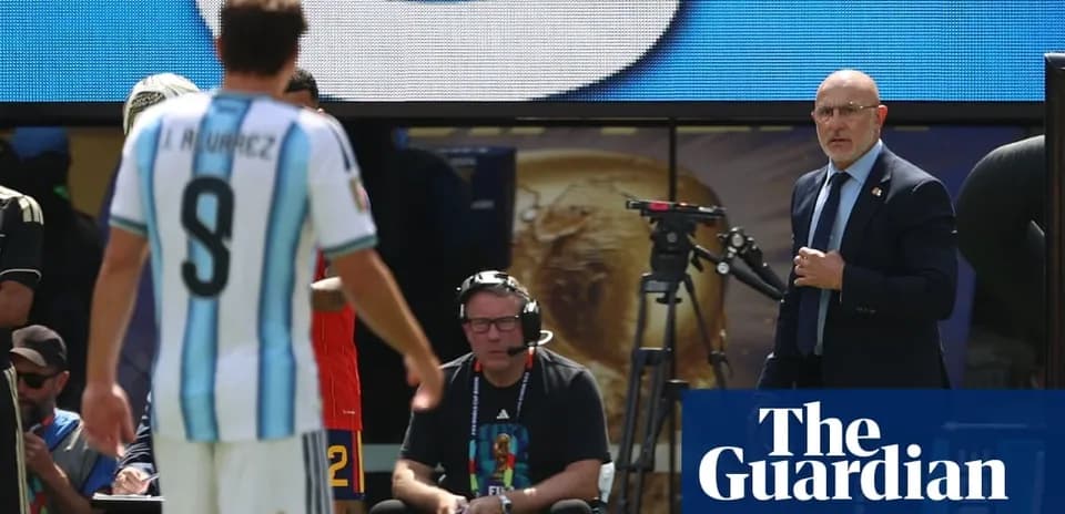 Argentina player substitutes while coach observes match
