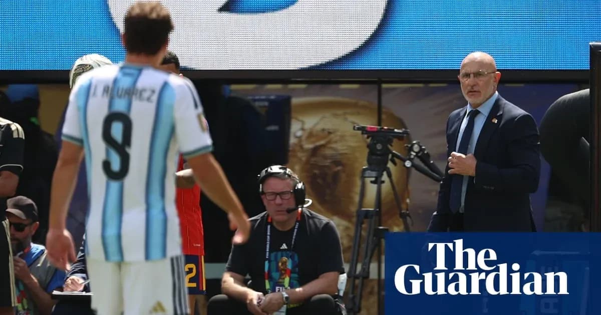 Argentina player substitutes while coach observes match