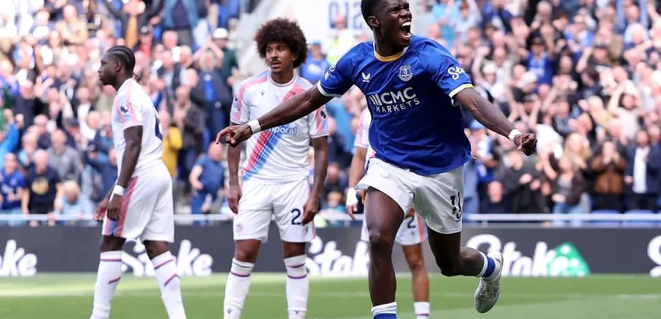 Player celebrating goal during match with crowd cheering