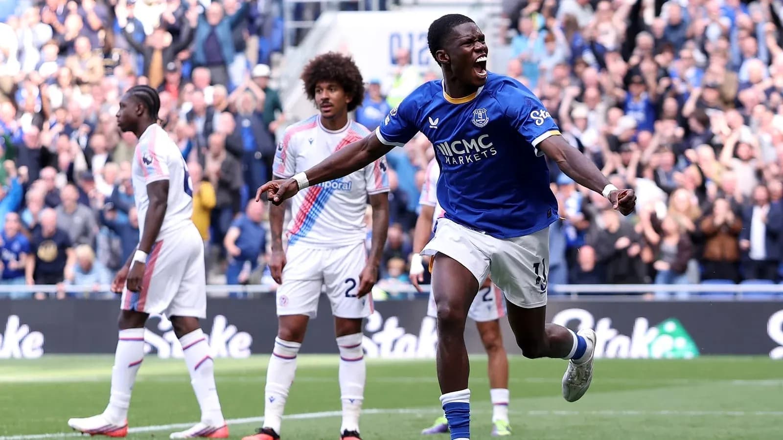 Player celebrating goal during match with crowd cheering