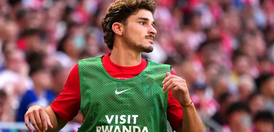 Player in training bib during match warm-up