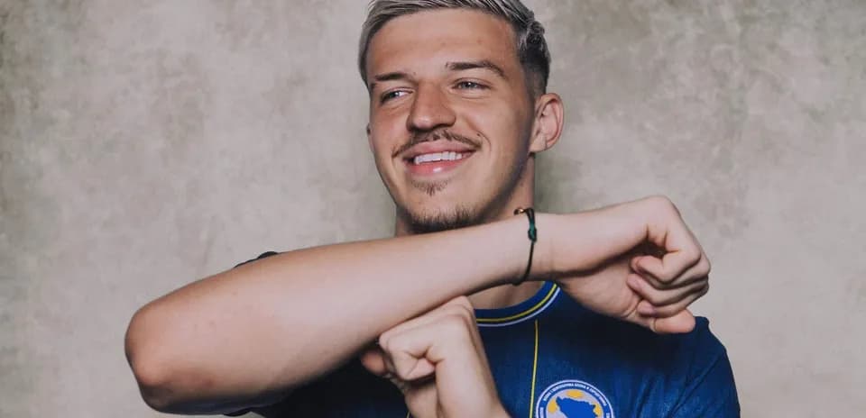 Player smiling while wearing national team jersey