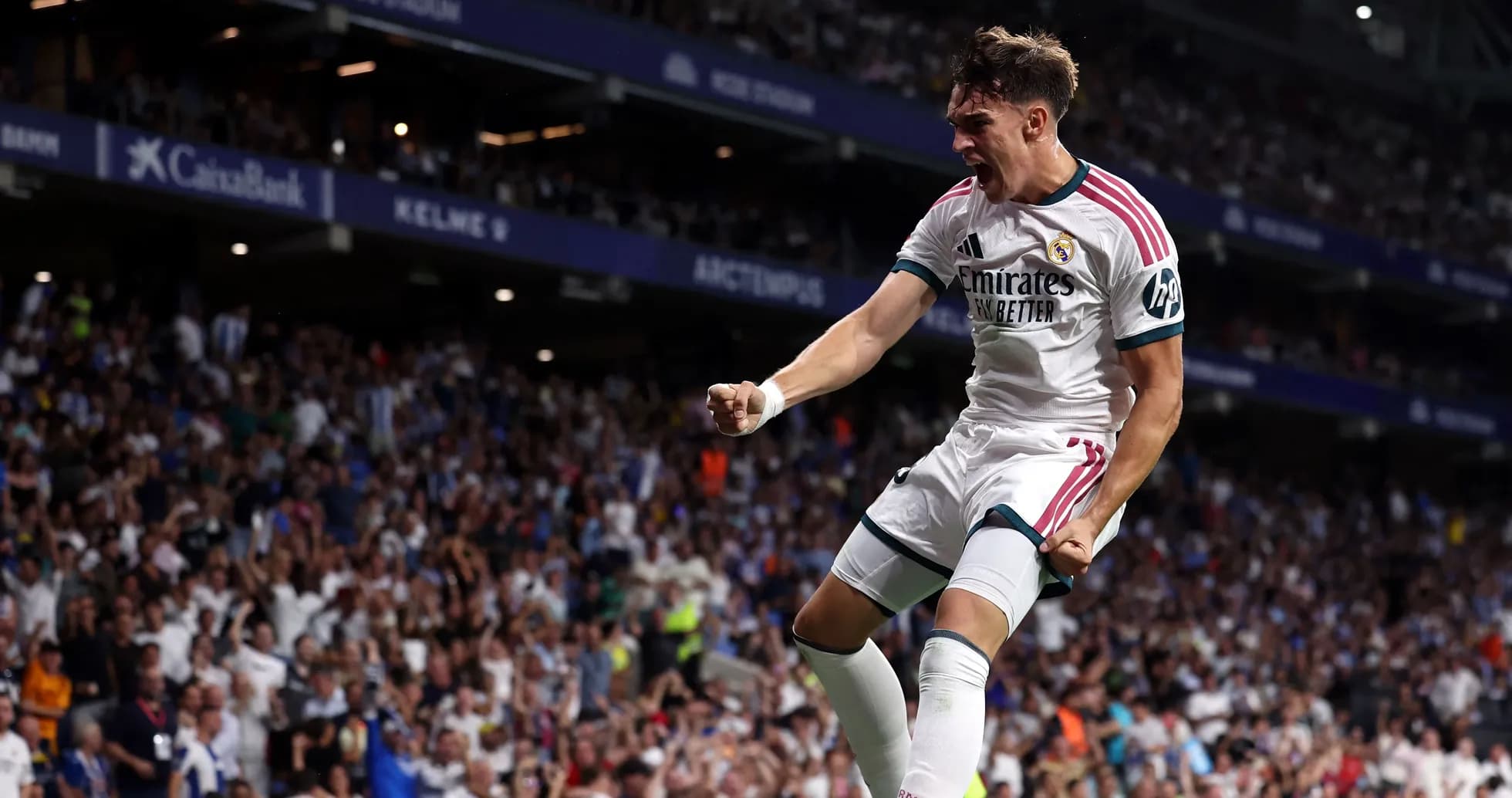Player celebrating goal with fans in stadium