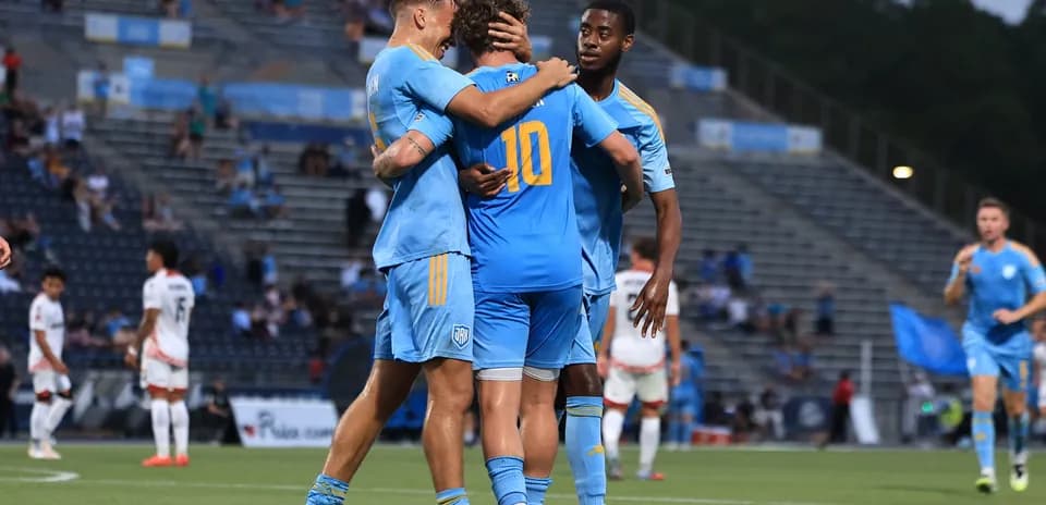 Players celebrating a goal during JAX match