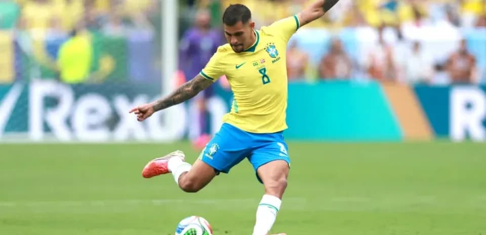 Brazilian player kicking soccer ball on field