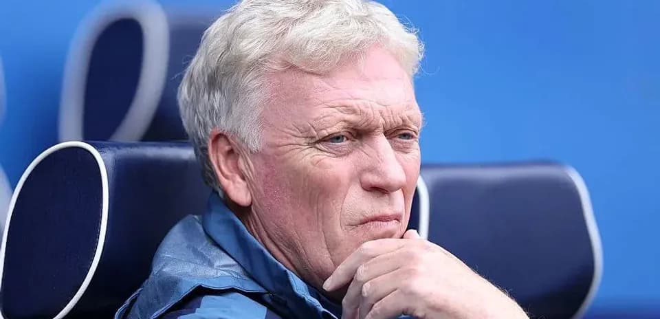 Coach sitting on bench during match