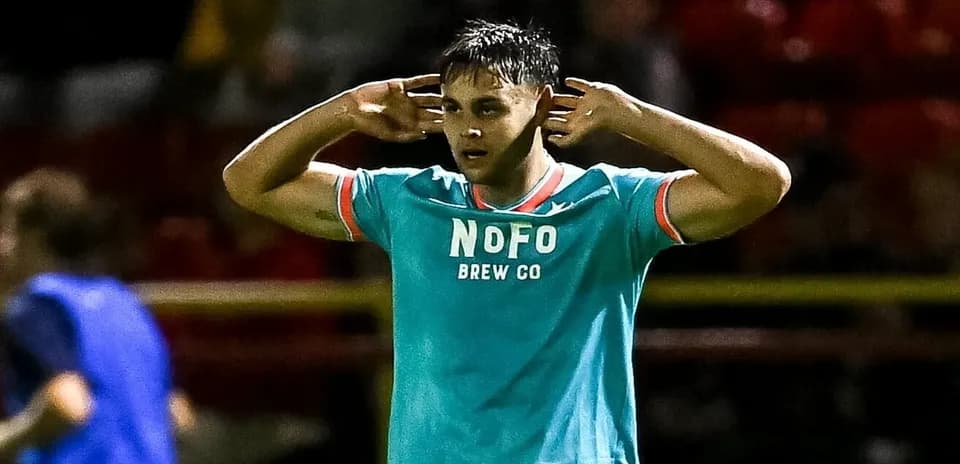Player celebrating with hands on ears during match