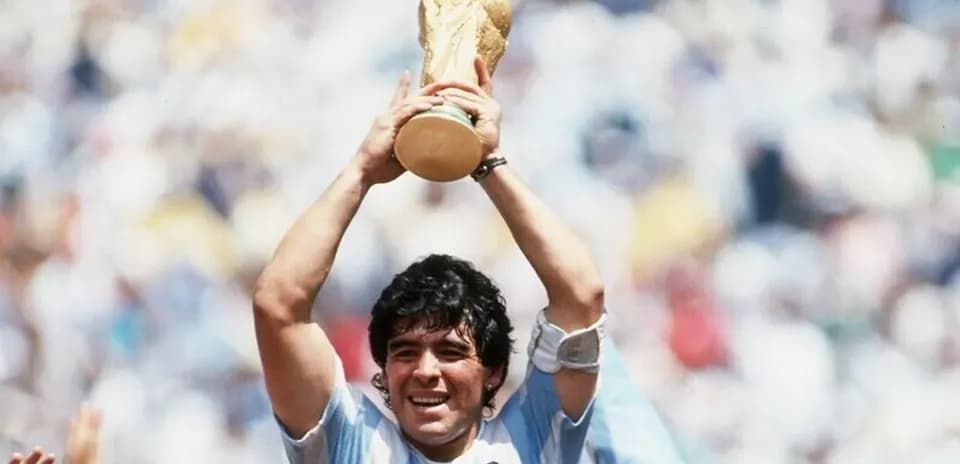 Player celebrating with World Cup trophy raised high