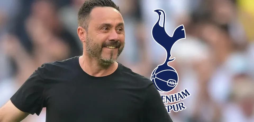 Manager celebrating with Tottenham Hotspur logo in background