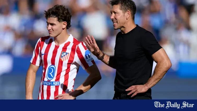 Atletico Madrid coach instructing player during match