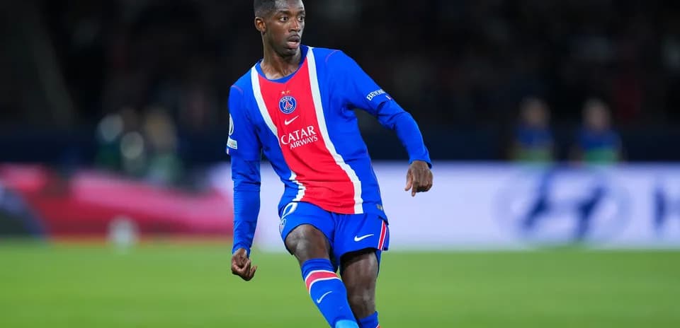 Player in PSG kit dribbling on the field
