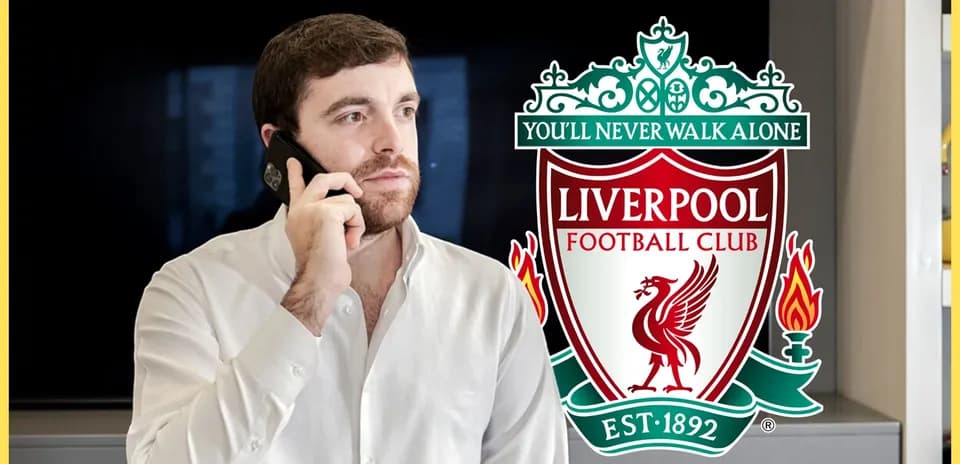 Man talking on phone with Liverpool FC logo in background