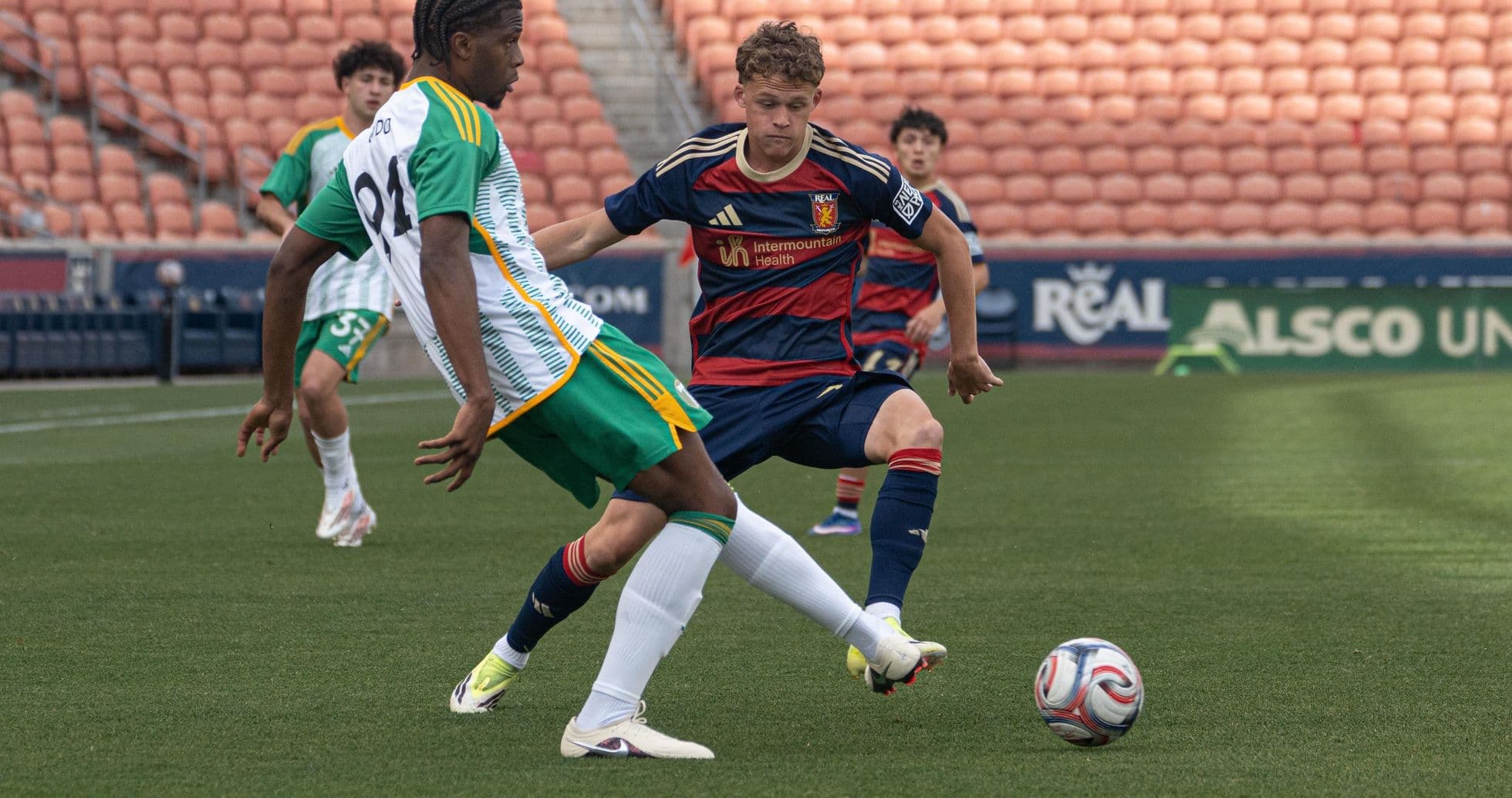 Two players competing for the ball in match