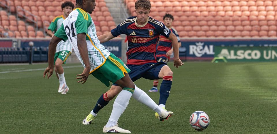 Two players competing for the ball in match