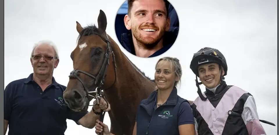 Three people posing with a horse at a stable
