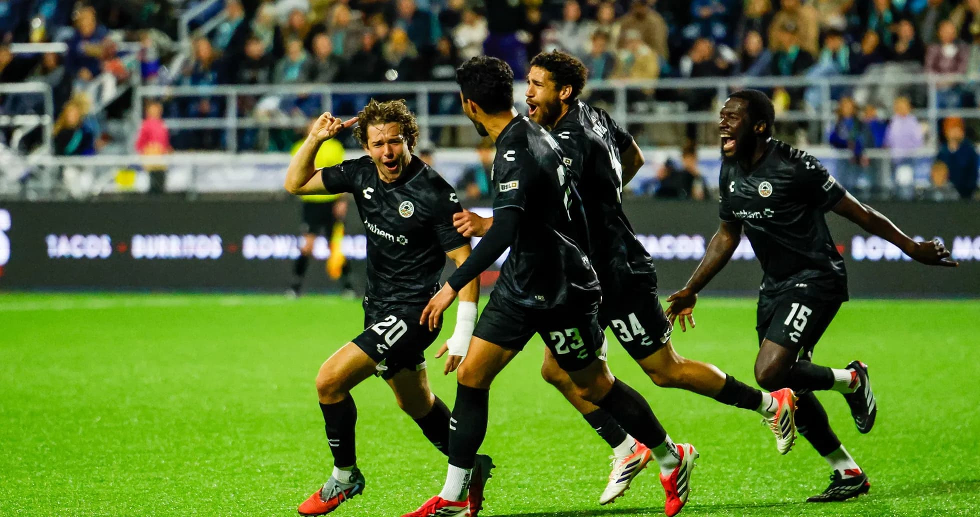 Players celebrating a goal during match
