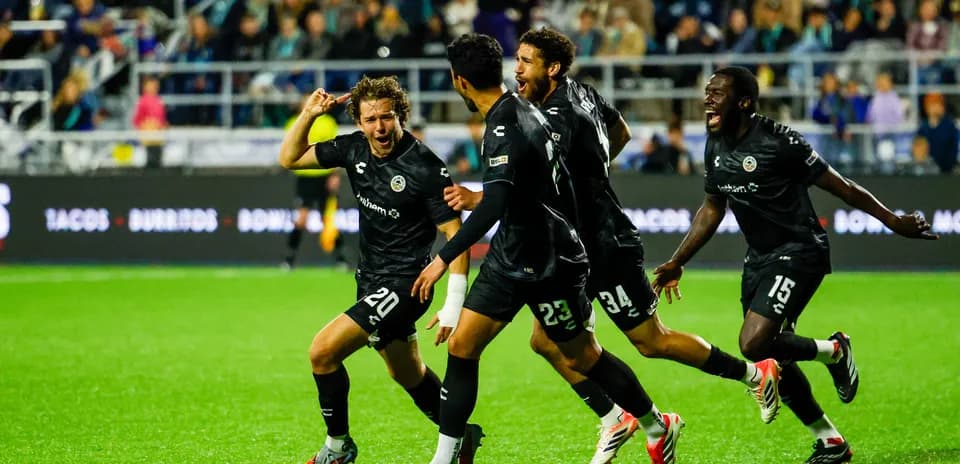 Players celebrating a goal during match